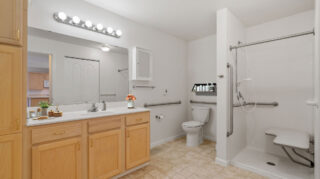Regent at Burnsville Care Suites, resident bathroom, open design with seated shower and safety features.