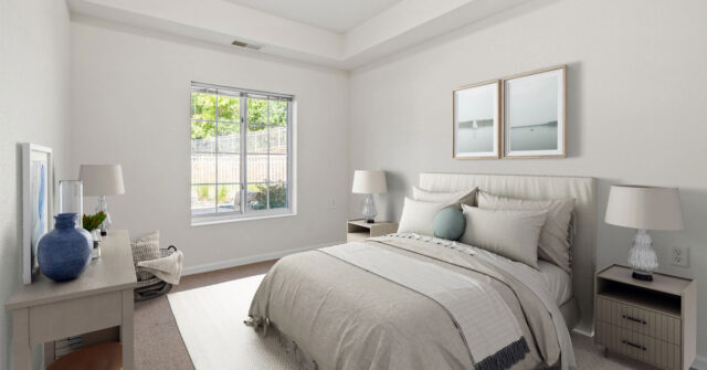 Regent at Burnsville Care Suites, resident bedroom, cozy bedding and bright window view.